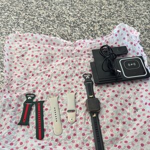 Apple Watch 5th Gen with Bands and wireless charging station.